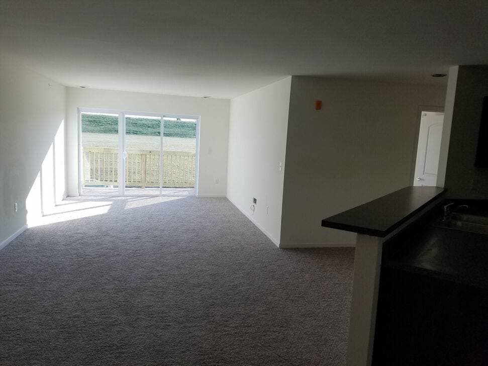 Spacious Layton 1900 apartment living room with patio doors